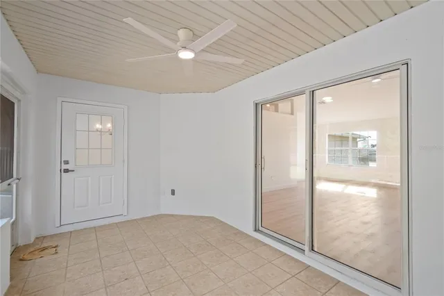 an empty room with large windows