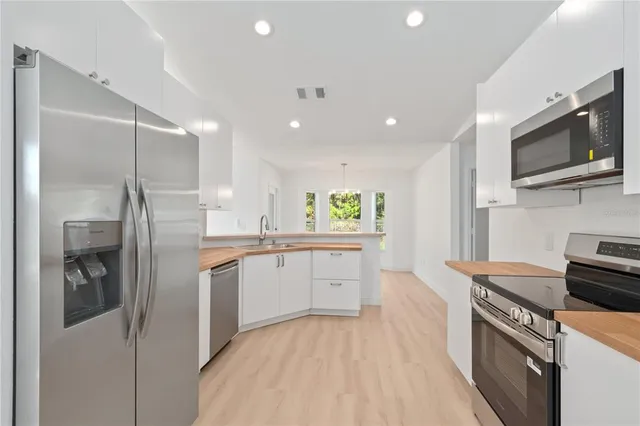a kitchen with a sink stainless steel appliances and cabinets