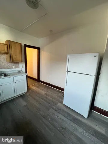 a view of a kitchen with wooden floor and a sink