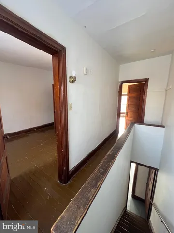 a view of an empty room and wooden floor