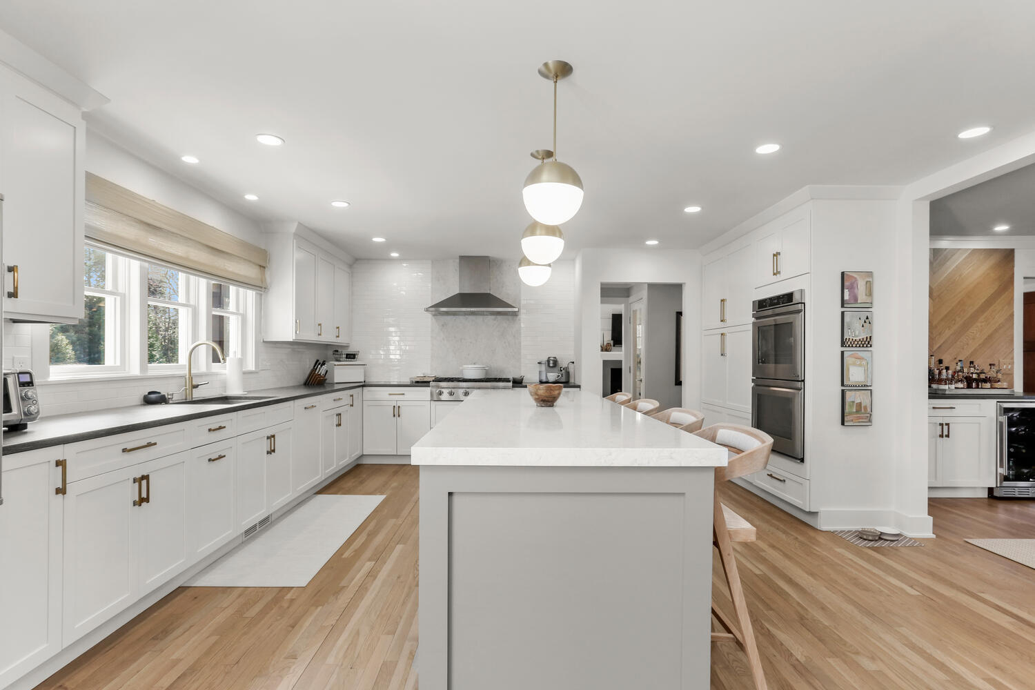 50 Summit Ridge Road New Canaan, CT 06840 - Photo 13 of 49 a large white kitchen with lots of counter space wooden floor and stainless steel appliances
