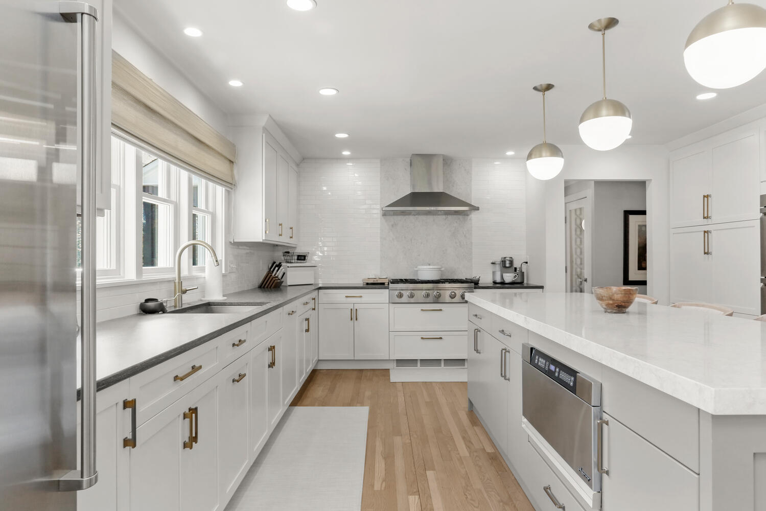 50 Summit Ridge Road New Canaan, CT 06840 - Photo 15 of 49 a large white kitchen with a stove a sink a refrigerator and a fireplace