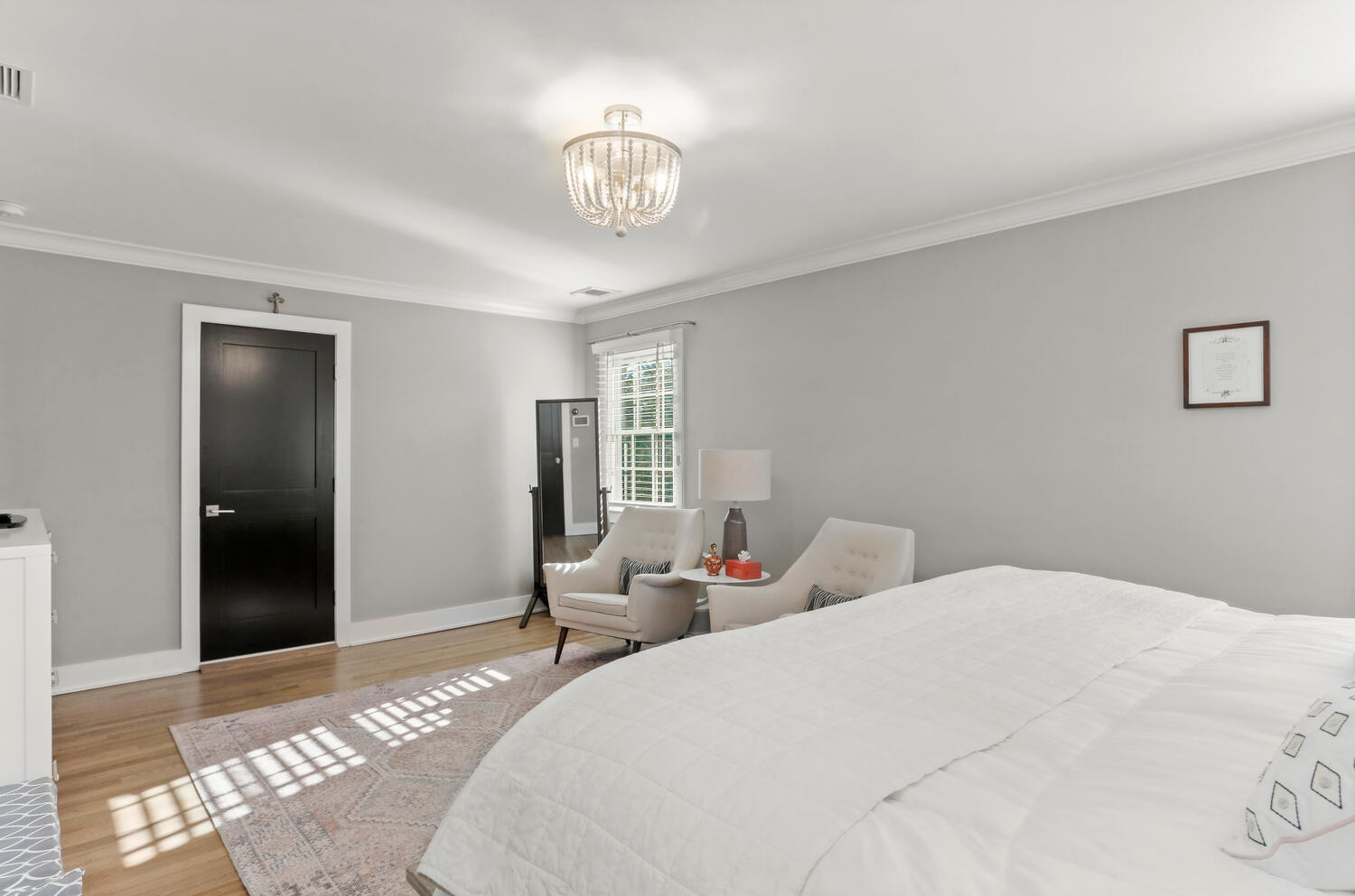 50 Summit Ridge Road New Canaan, CT 06840 - Photo 30 of 49 a bedroom with a bed and a chandelier