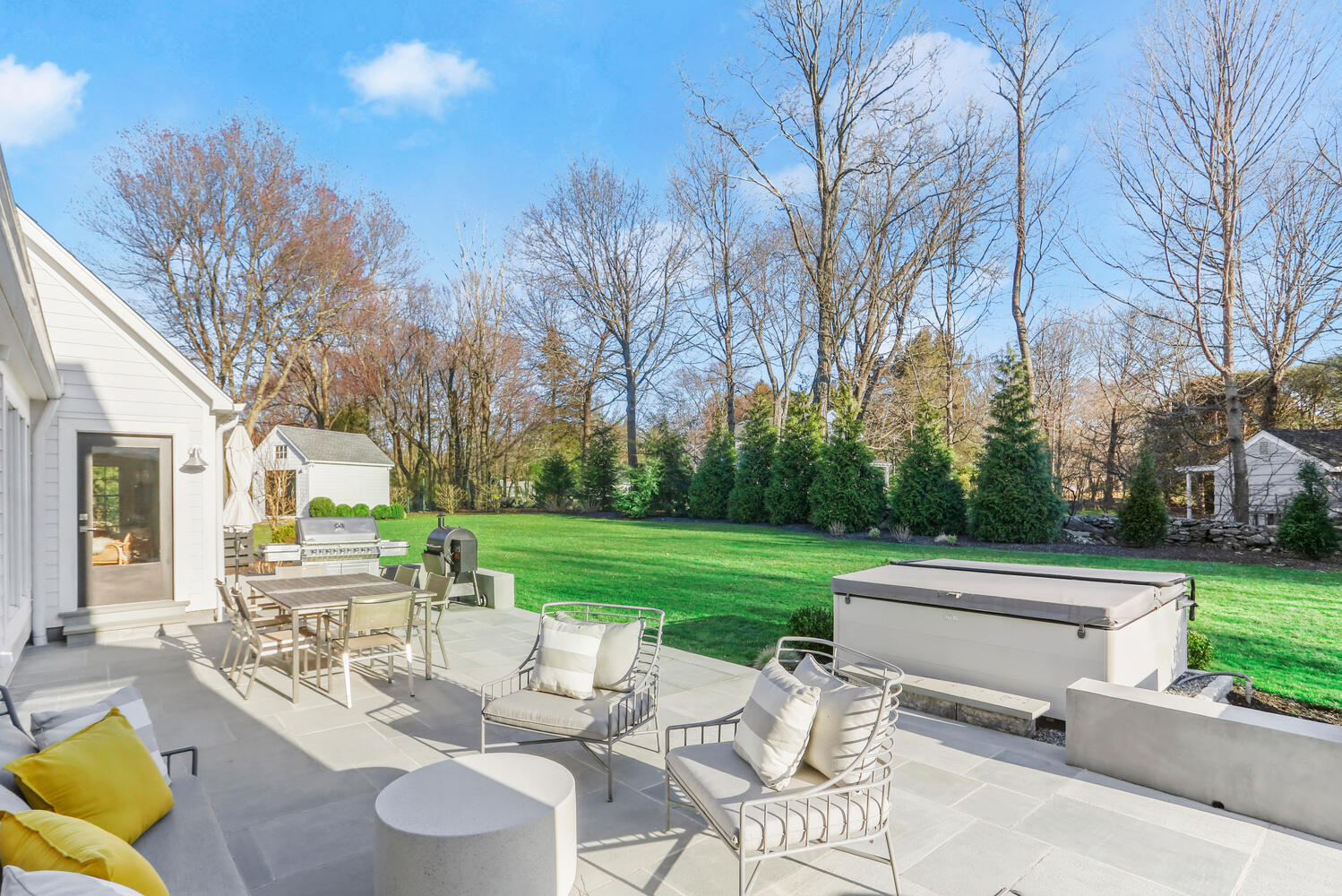 50 Summit Ridge Road New Canaan, CT 06840 - Photo 47 of 49 a view of a patio with couches chairs and a big yard