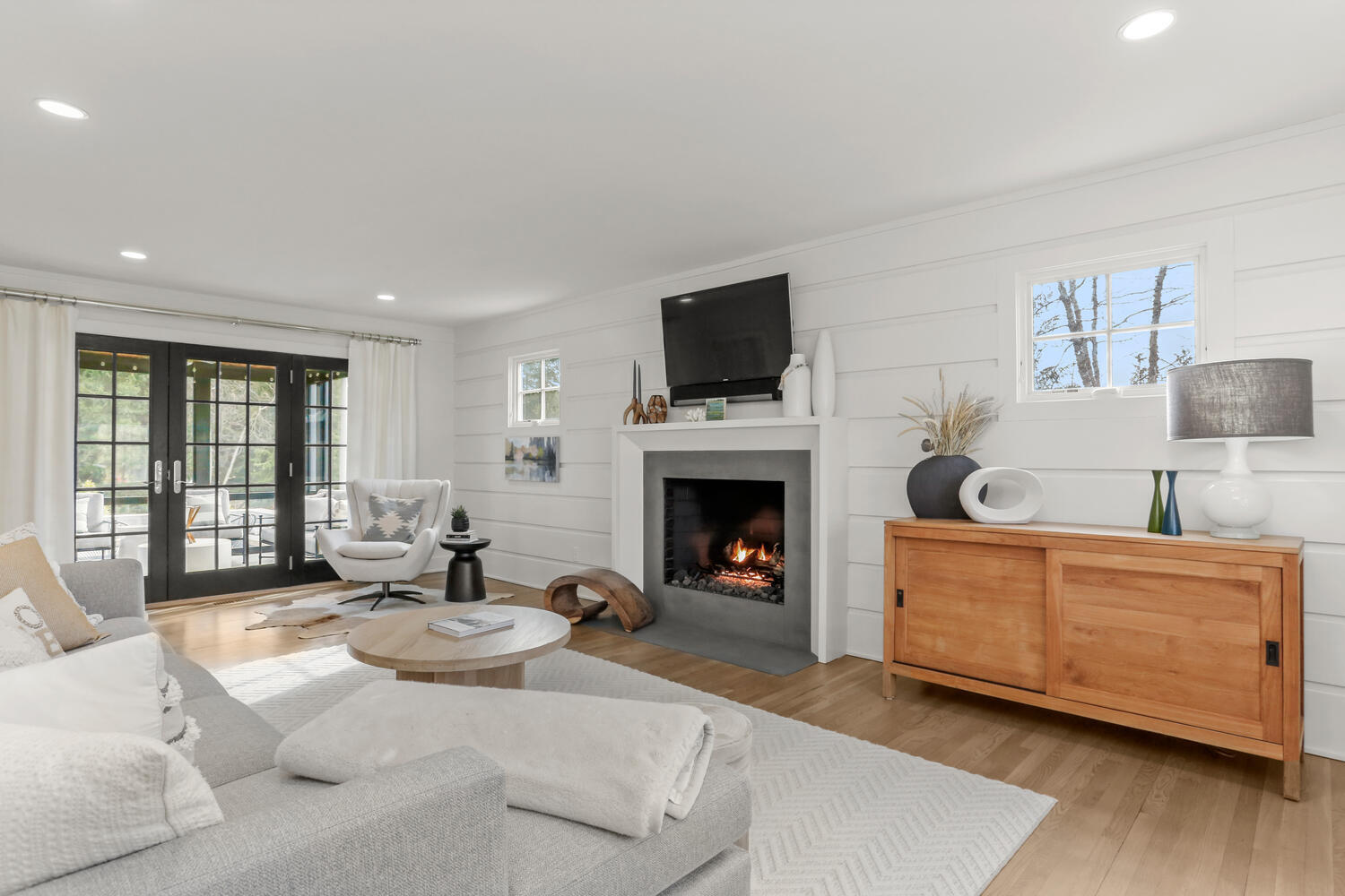 50 Summit Ridge Road New Canaan, CT 06840 - Photo 7 of 49 a living room with furniture a flat screen tv and a fireplace