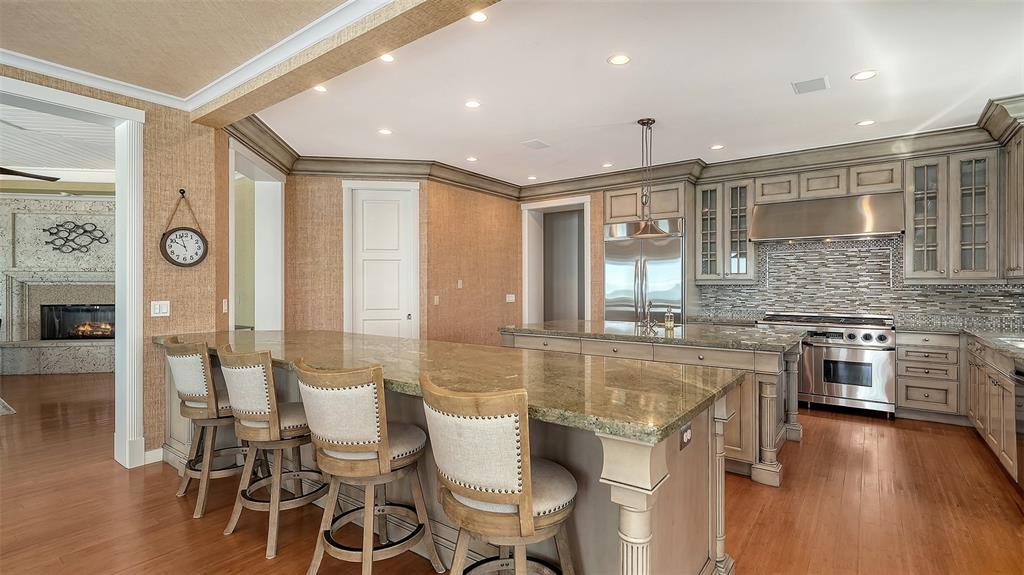 6477 Gulfside Road Longboat Key, FL 34228 - Photo 21 of 65 a large kitchen with a table and chairs