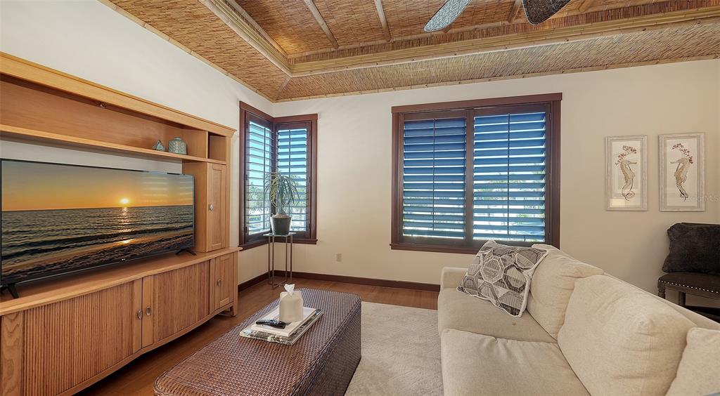 6477 Gulfside Road Longboat Key, FL 34228 - Photo 27 of 65 a living room with furniture and a flat screen tv