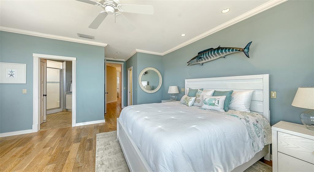 6477 Gulfside Road Longboat Key, FL 34228 - Photo 30 of 65 a bedroom with a bed and a chandelier