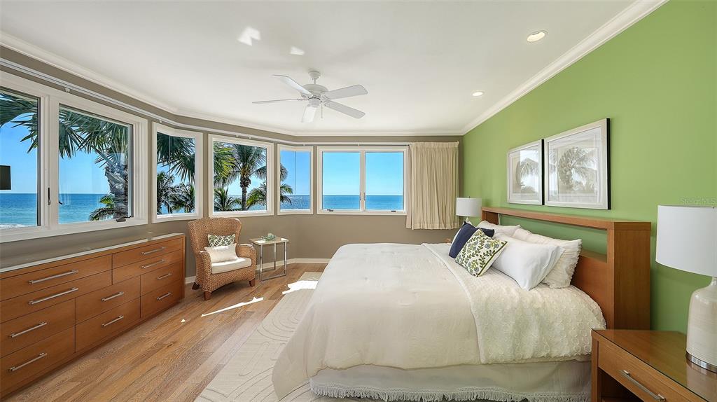 6477 Gulfside Road Longboat Key, FL 34228 - Photo 33 of 65 a bedroom with a large bed and a large window