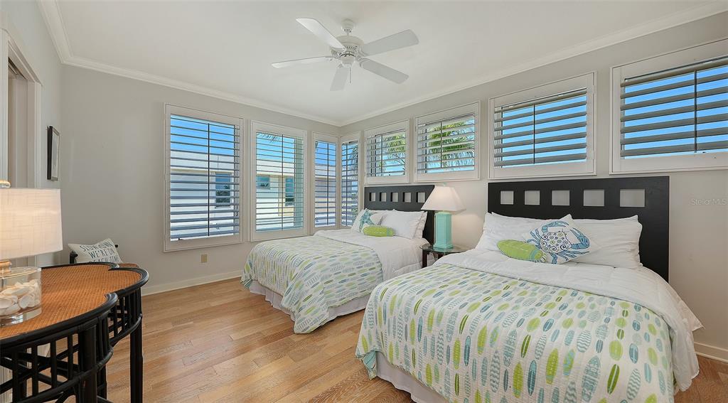 6477 Gulfside Road Longboat Key, FL 34228 - Photo 37 of 65 a bedroom with two beds and a dresser