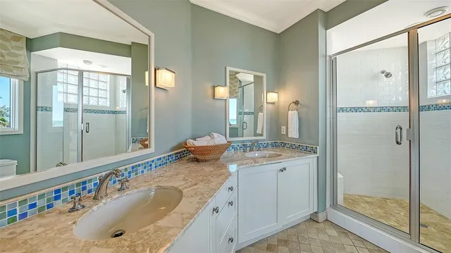 a bathroom with a granite countertop sink mirror and toilet