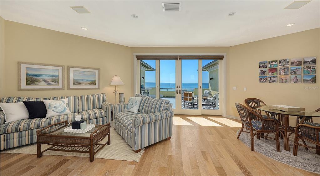 6477 Gulfside Road Longboat Key, FL 34228 - Photo 40 of 65 a living room with furniture and a wooden floor