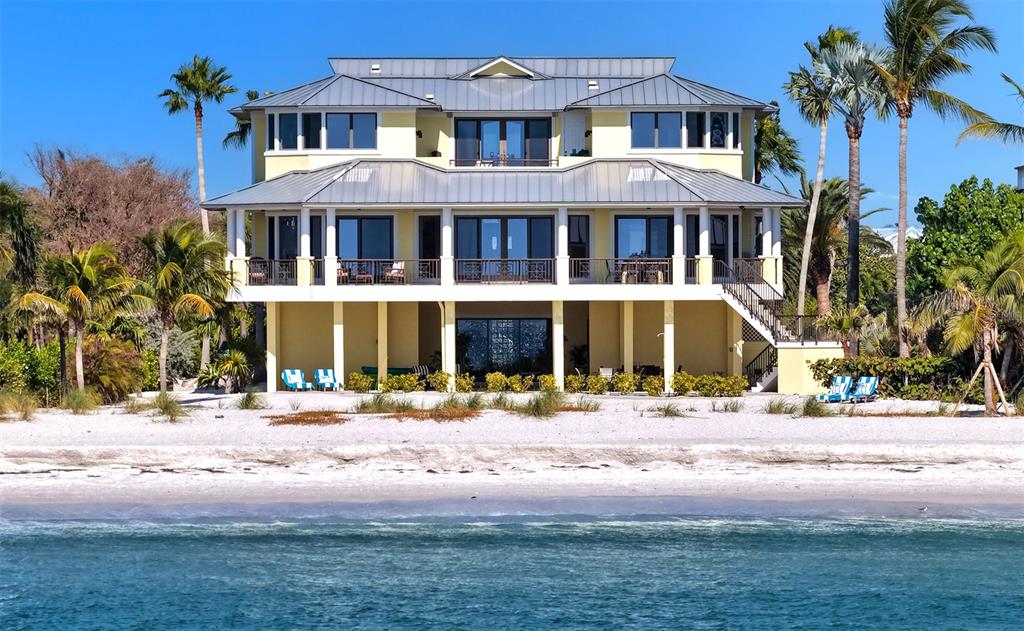 6477 Gulfside Road Longboat Key, FL 34228 - Photo 4 of 65 a front view of a residential apartment building with a yard