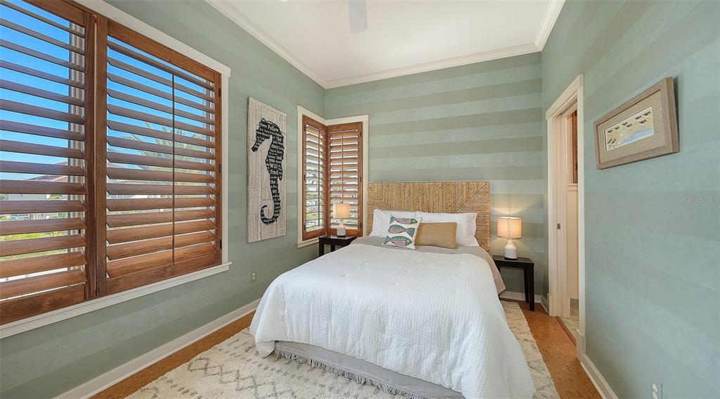 6477 Gulfside Road Longboat Key, FL 34228 - Photo 45 of 65 a bedroom with a bed and a window