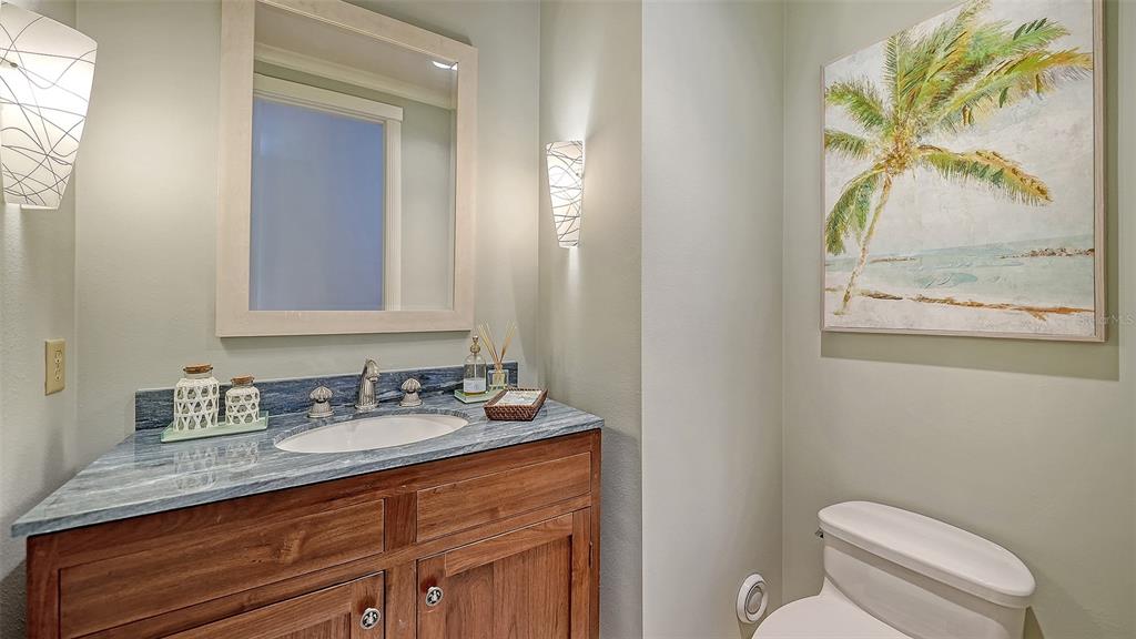6477 Gulfside Road Longboat Key, FL 34228 - Photo 48 of 65 a bathroom with a granite countertop sink mirror and toilet