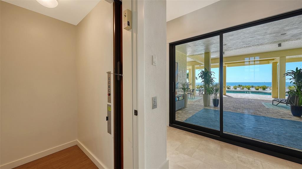 6477 Gulfside Road Longboat Key, FL 34228 - Photo 9 of 65 a view of a room with wooden floor and floor to ceiling window