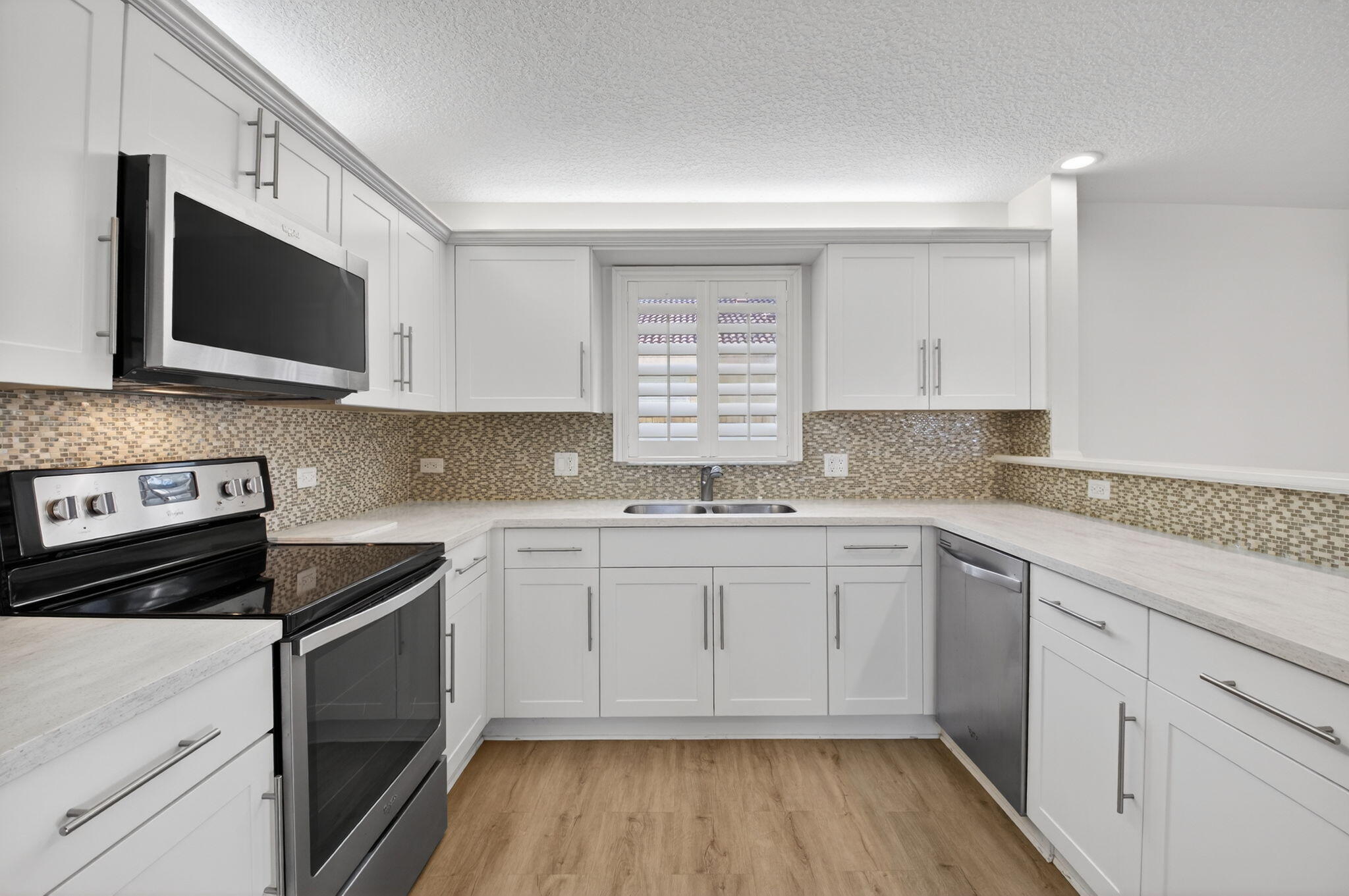 4517 Northwest 5th Avenue Boca Raton, FL 33431 - Photo 11 of 40 a kitchen with stainless steel appliances granite countertop a stove a sink and a microwave