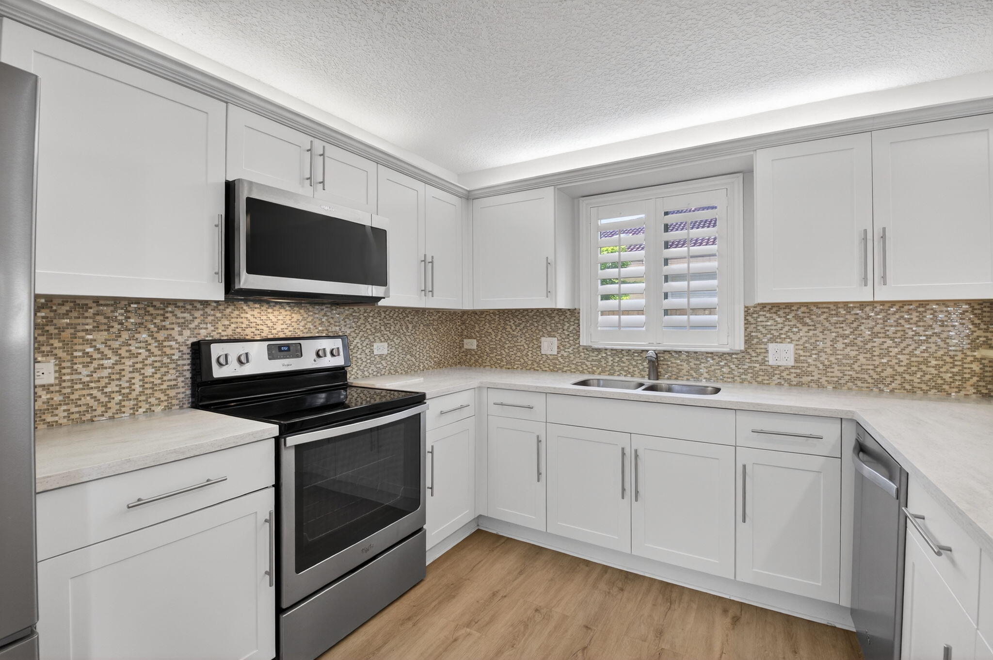 4517 Northwest 5th Avenue Boca Raton, FL 33431 - Photo 12 of 40 a kitchen with sink a microwave and cabinets