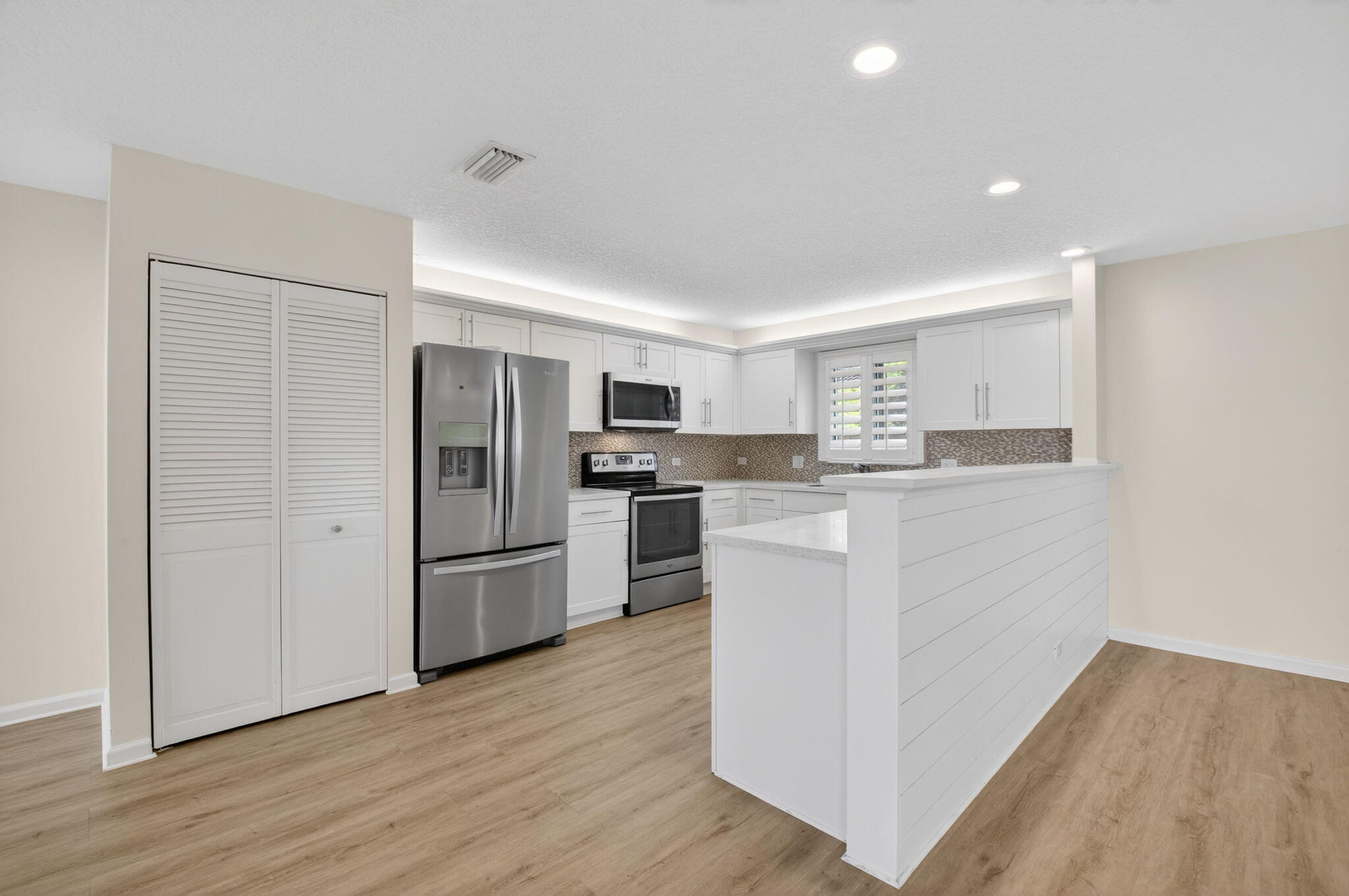 4517 Northwest 5th Avenue Boca Raton, FL 33431 - Photo 14 of 40 a kitchen with stainless steel appliances granite countertop a refrigerator and a stove top oven