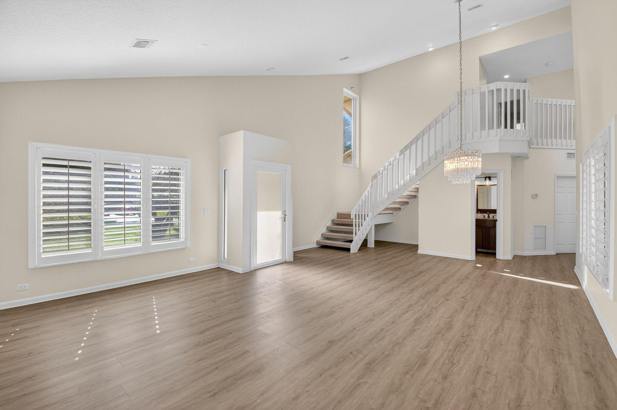 4517 Northwest 5th Avenue Boca Raton, FL 33431 - Photo 19 of 40 a view of an empty room with wooden floor and stairs