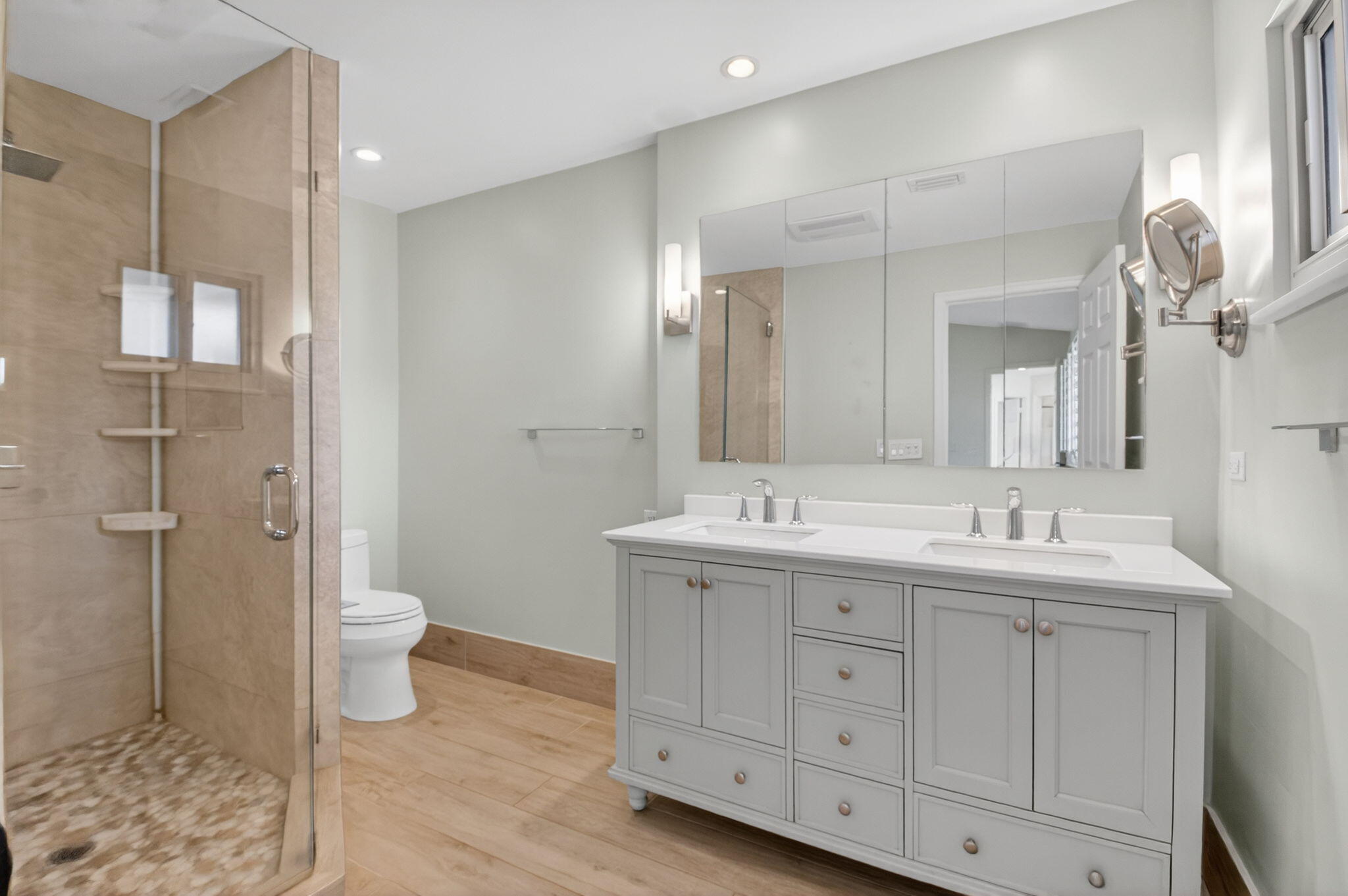 4517 Northwest 5th Avenue Boca Raton, FL 33431 - Photo 24 of 40 a bathroom with a double vanity sink toilet and shower