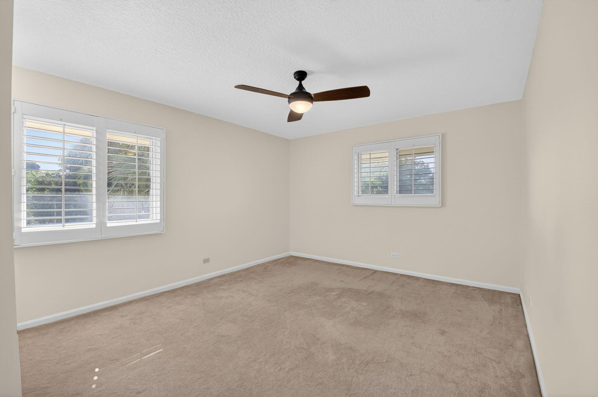 4517 Northwest 5th Avenue Boca Raton, FL 33431 - Photo 28 of 40 an empty room with a window and a ceiling fan