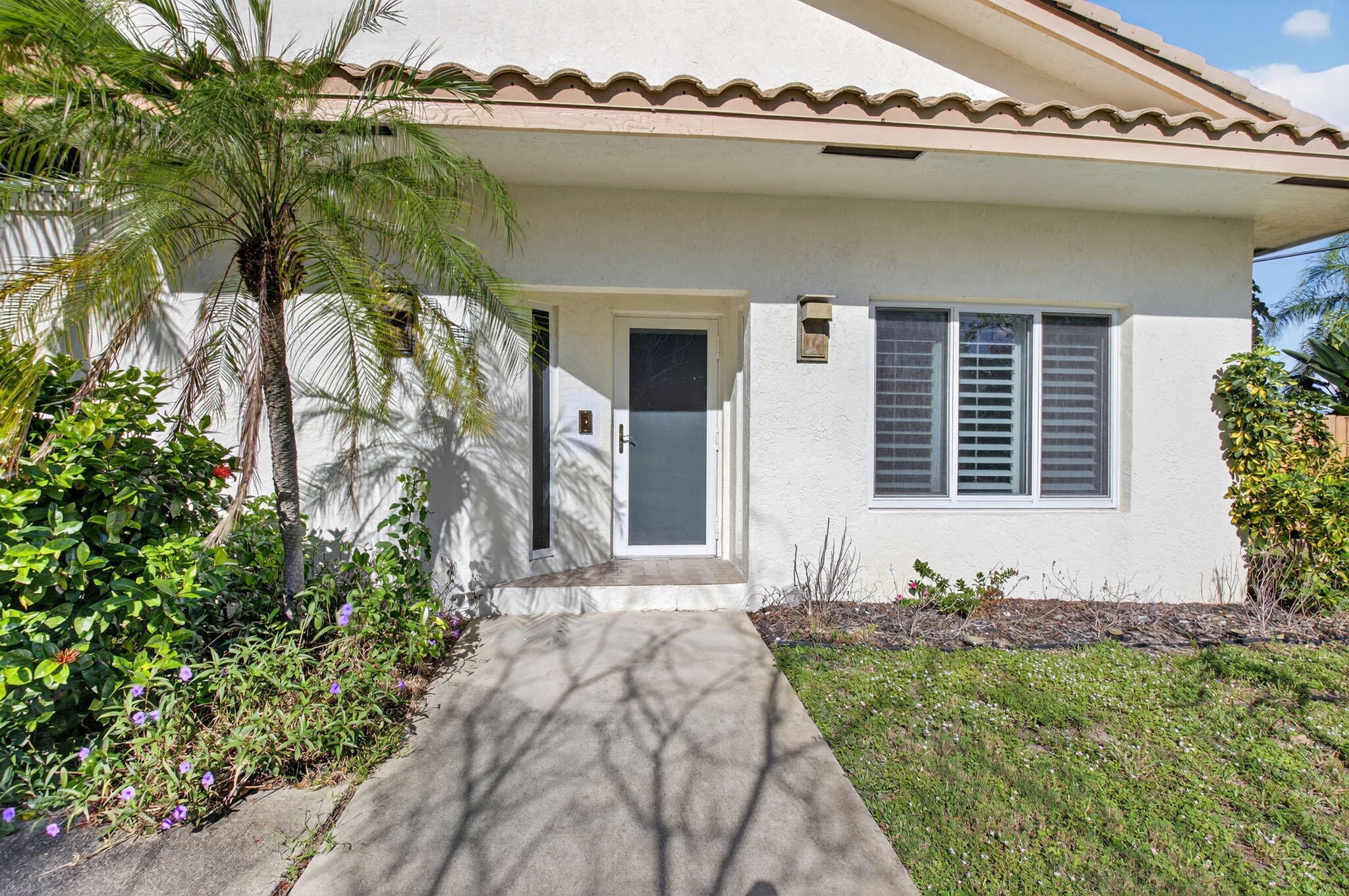 4517 Northwest 5th Avenue Boca Raton, FL 33431 - Photo 38 of 40 a front view of a house with garden