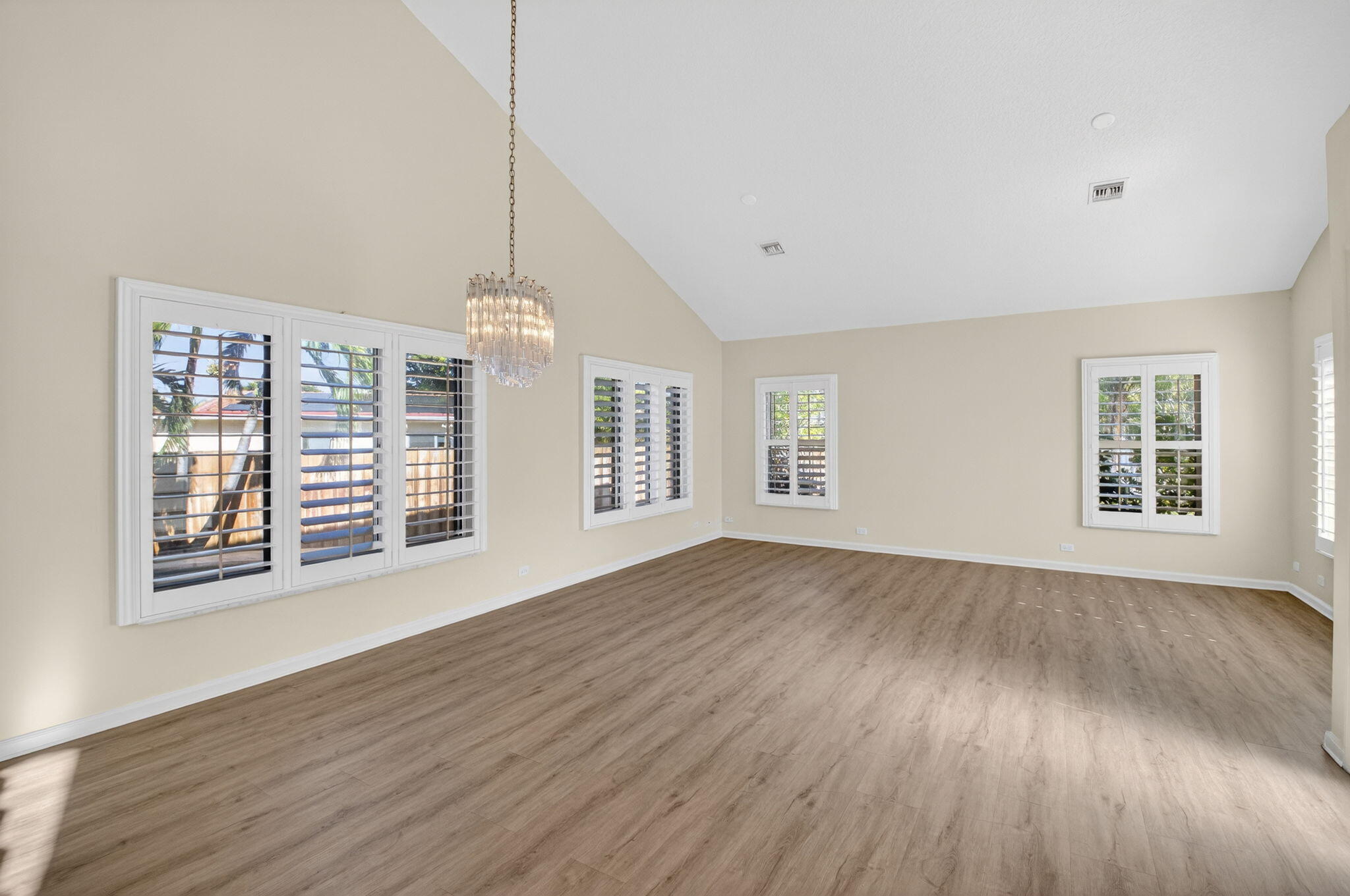 4517 Northwest 5th Avenue Boca Raton, FL 33431 - Photo 4 of 40 a view of an empty room with wooden floor and a window