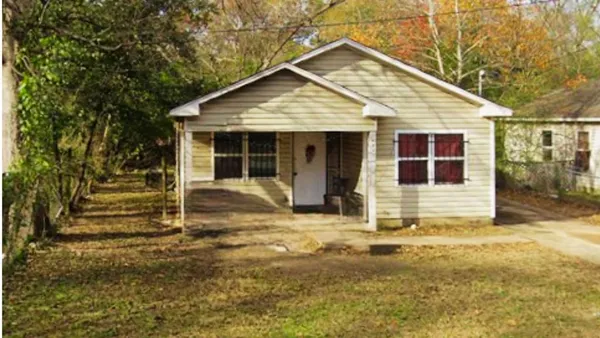 a view of a house with wooden fence