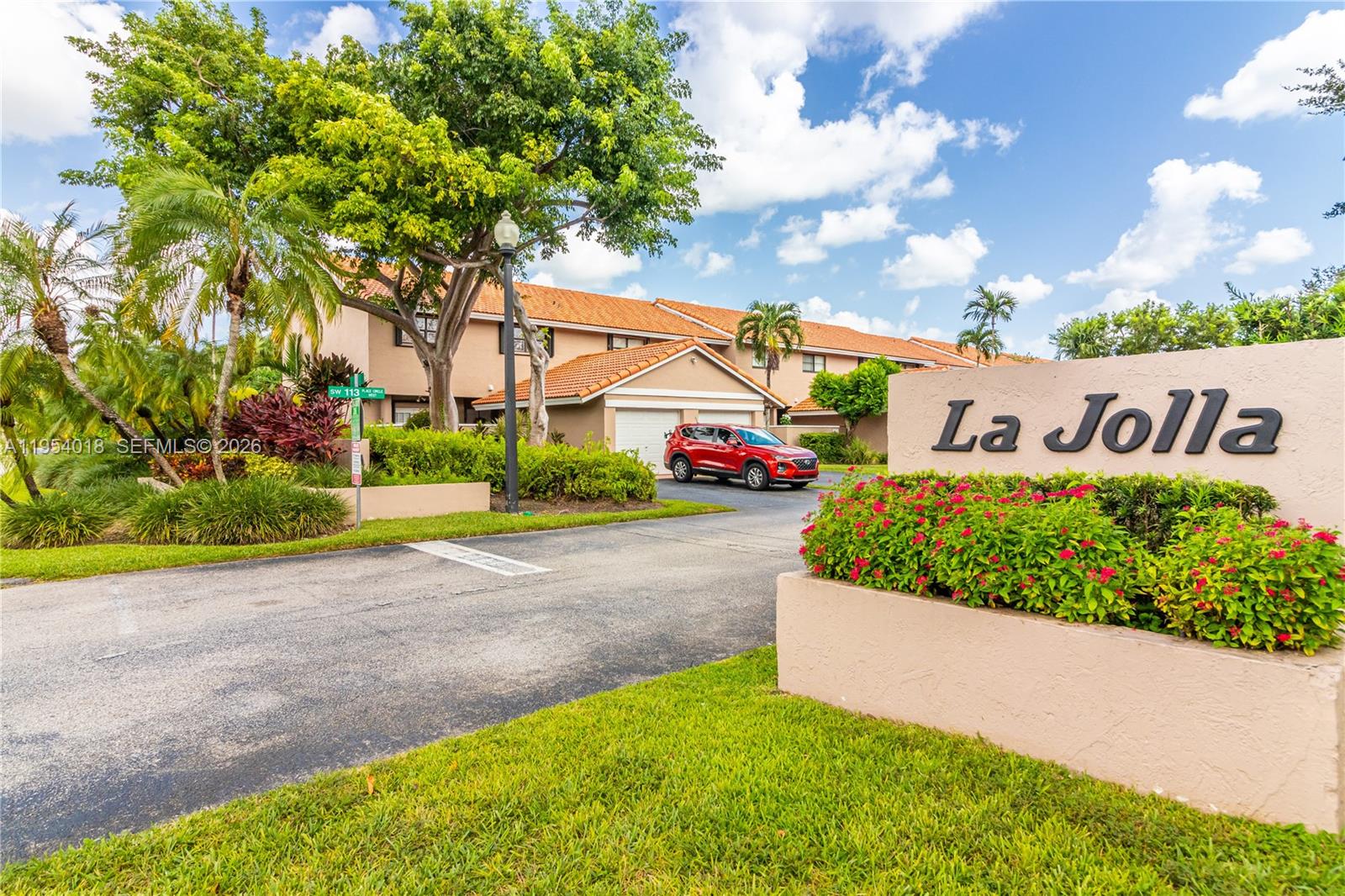 a sign that is sitting in front of flowers