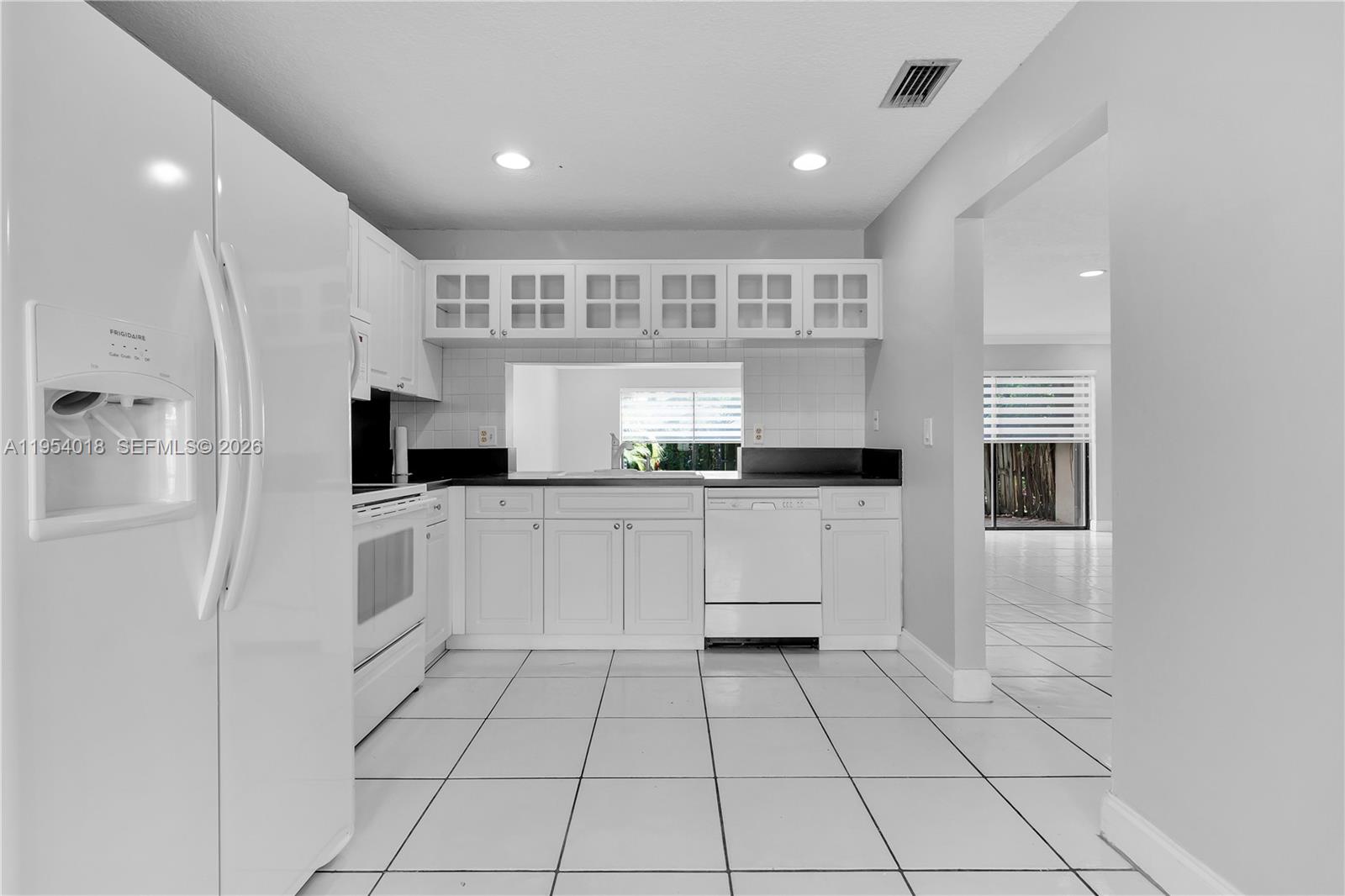 11668 Southwest 91st Terrace, Unit 11668 Miami, FL 33176 - Photo 16 of 39 a kitchen with white cabinets and appliances