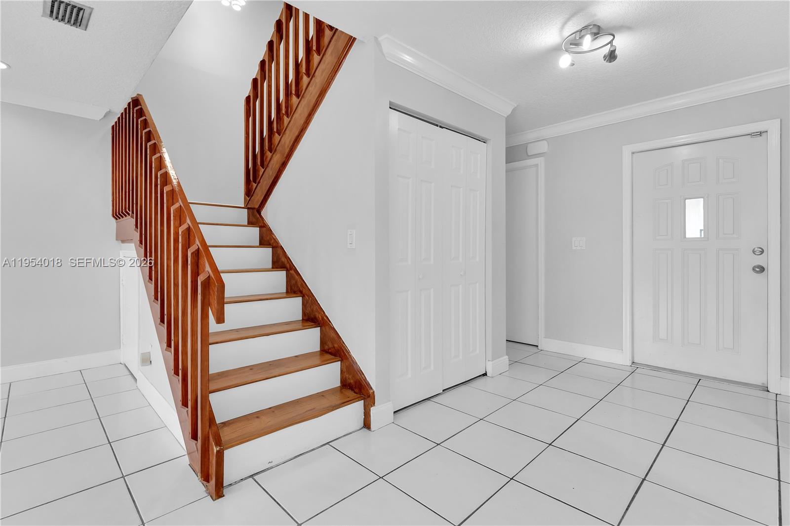 11668 Southwest 91st Terrace, Unit 11668 Miami, FL 33176 - Photo 17 of 39 a view of front door with hallway and stairs