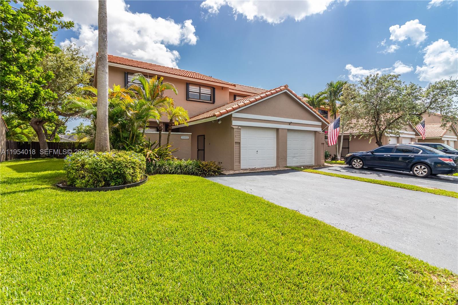 11668 Southwest 91st Terrace, Unit 11668 Miami, FL 33176 - Photo 4 of 39 a front view of a house with garden