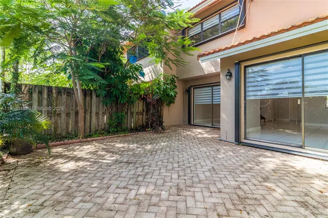 a backyard of a house with plants and trees