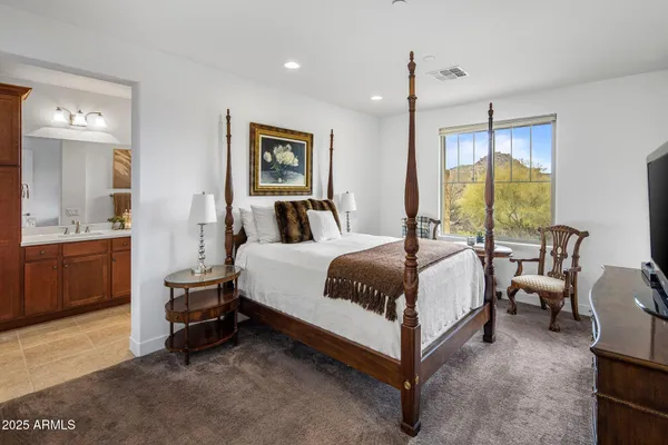 a spacious bedroom with a bed and a couch