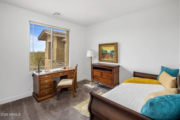 a bedroom with a bed and a table in it