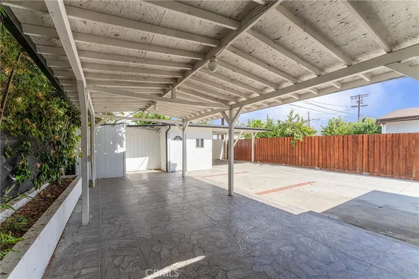 a view of a house with a yard and potted plants