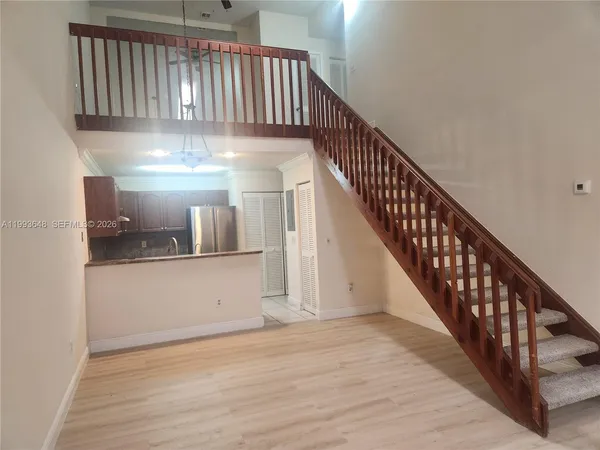 a kitchen with granite countertop a refrigerator and a sink