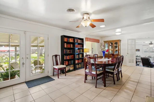 a view of a dining room with furniture and a potted plant