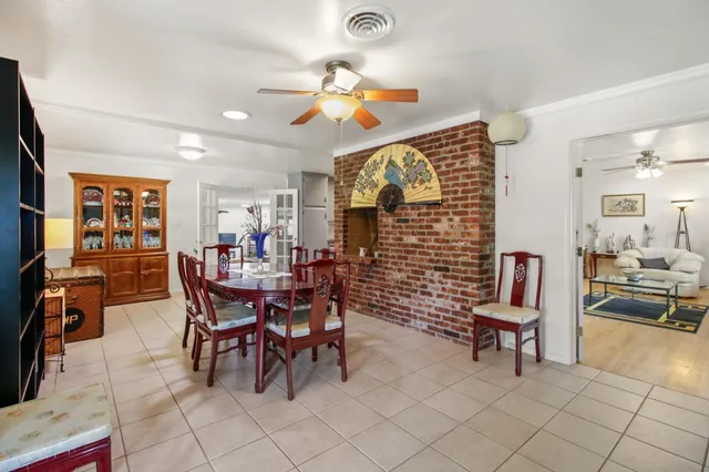 a dining room with furniture and wooden floor