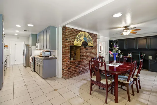 a kitchen with kitchen island granite countertop a sink stainless steel appliances and cabinets