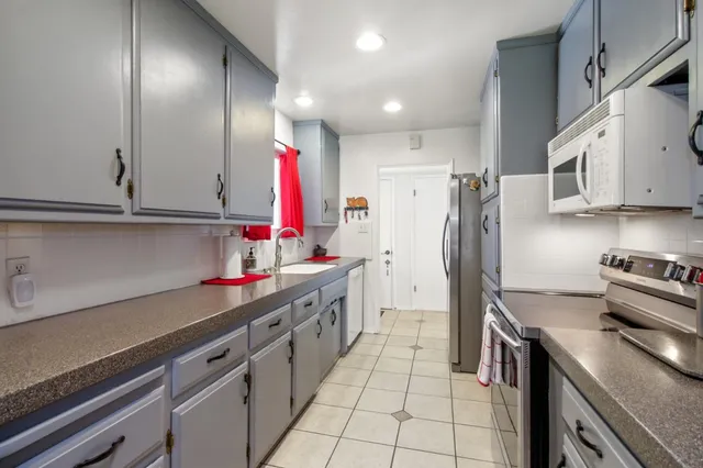 a kitchen with stainless steel appliances and a sink