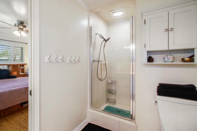 a bedroom with a bed and a flat tv screen on dresser