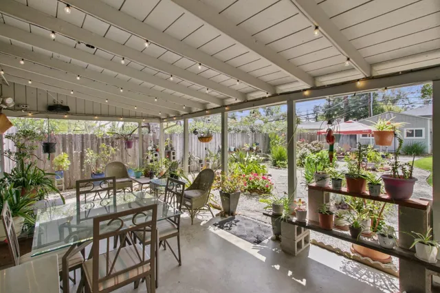 a view of a house with backyard and a tree