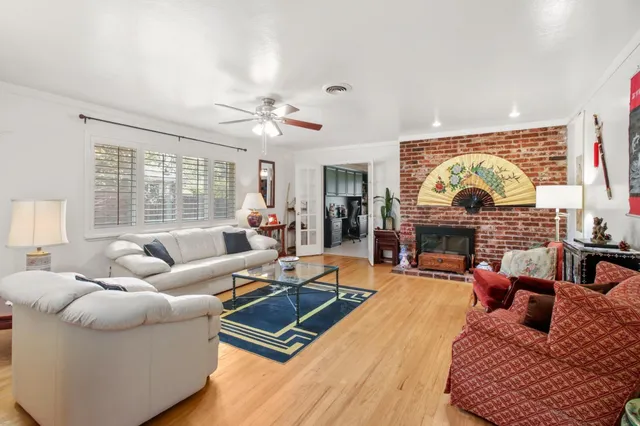 a living room with furniture fireplace and a large window