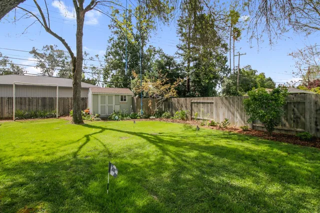 a view of a house with backyard and sitting area