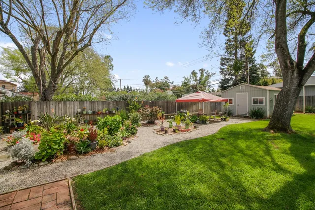 a view of a patio with table and chairs under an umbrella
