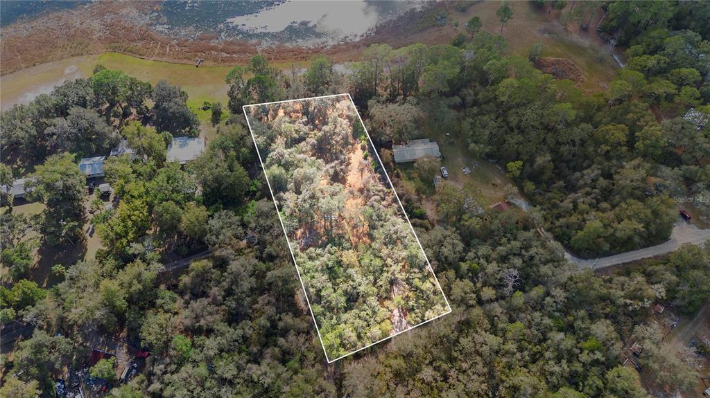 Tbd Southeast 256th Avenue Umatilla, FL 32784 - Photo 27 of 30 a view of a lake with a building in the background