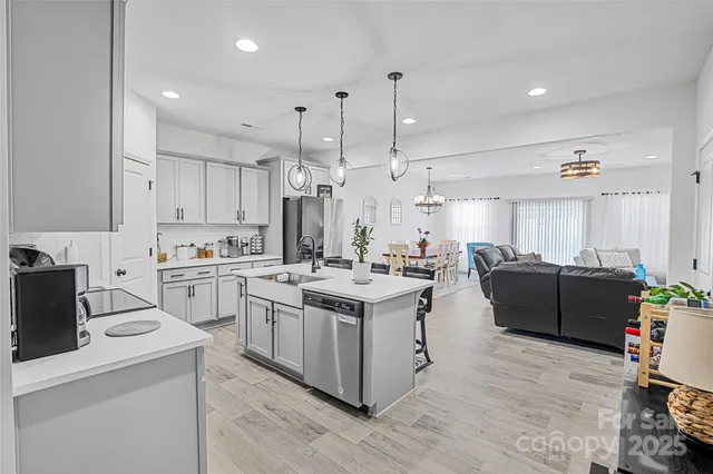 a kitchen with cabinets and wooden floor