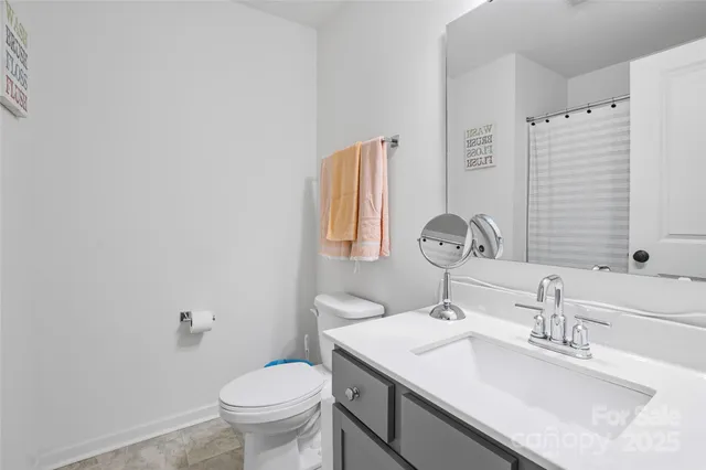a bathroom with a sink toilet and a mirror